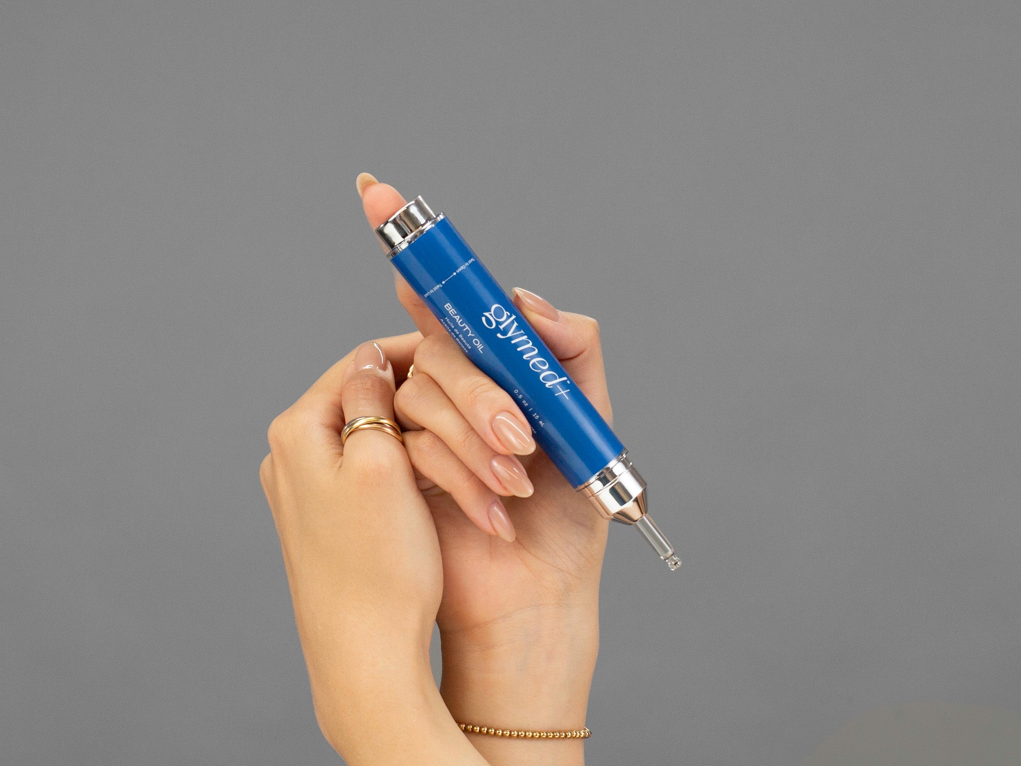 Closeup of Laziza from LAZ Skincare holding a bottle of GlyMed Beauty Oil in her hands