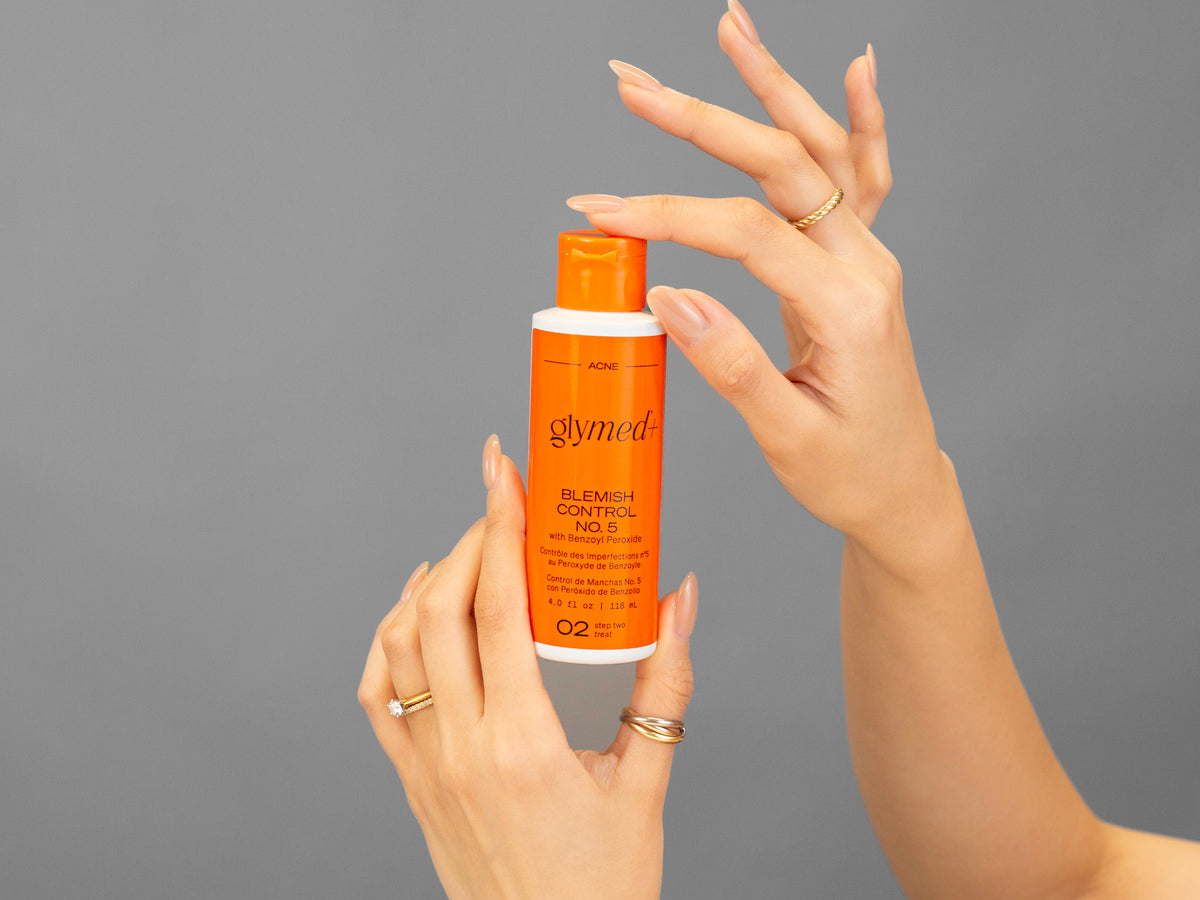 Closeup of Laziza from LAZ Skincare holding up a bottle of GlyMed Blemish Control No. 5