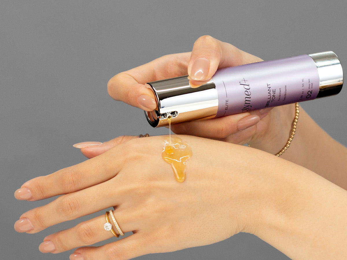 Laziza from LAZ Skincare demonstrating the texture and application of GlyMed Brilliant Tone on her hand