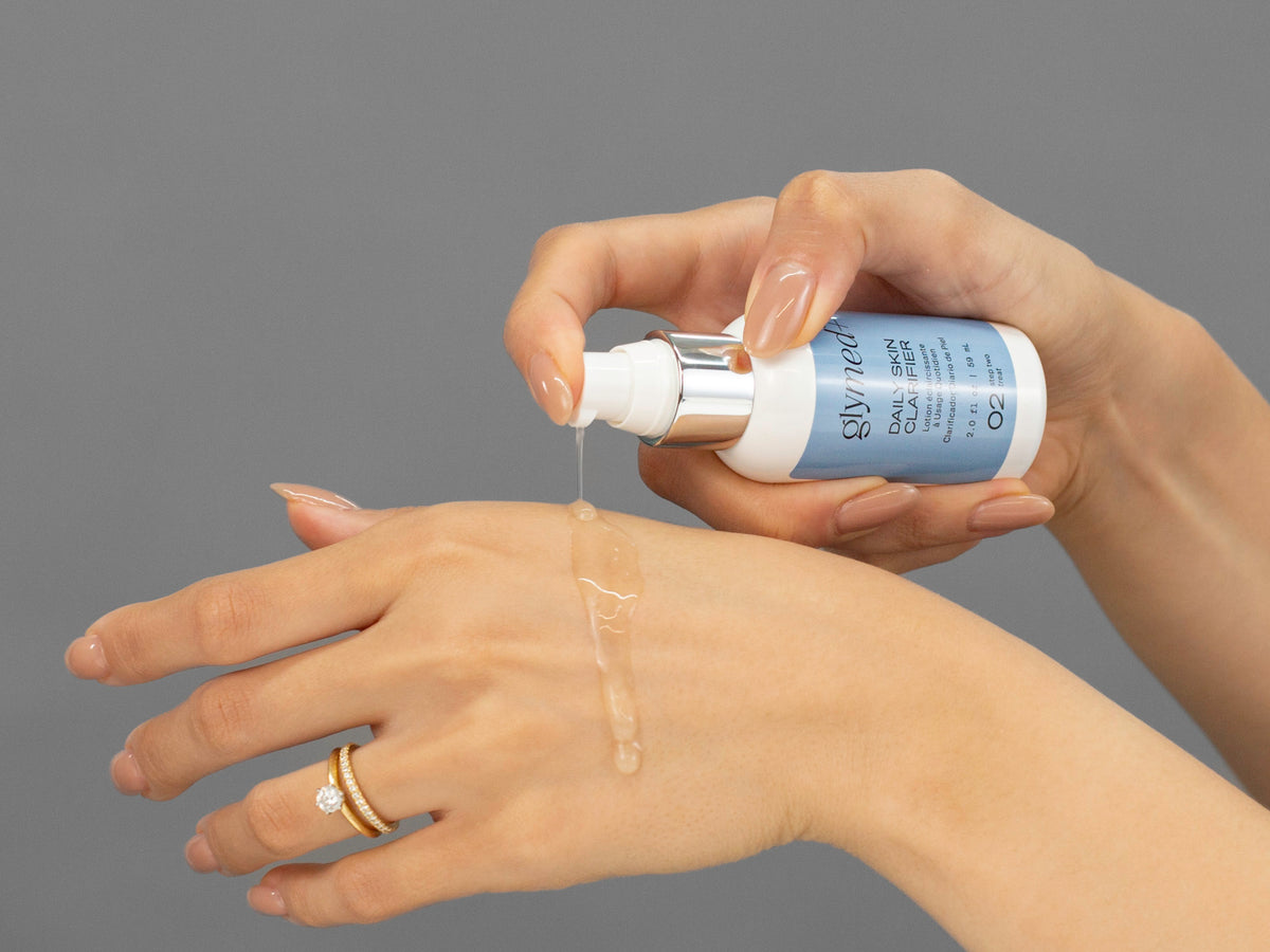 Laziza from LAZ Skincare demonstrating the texture and application of GlyMed Daily Skin Clarifier on her hand