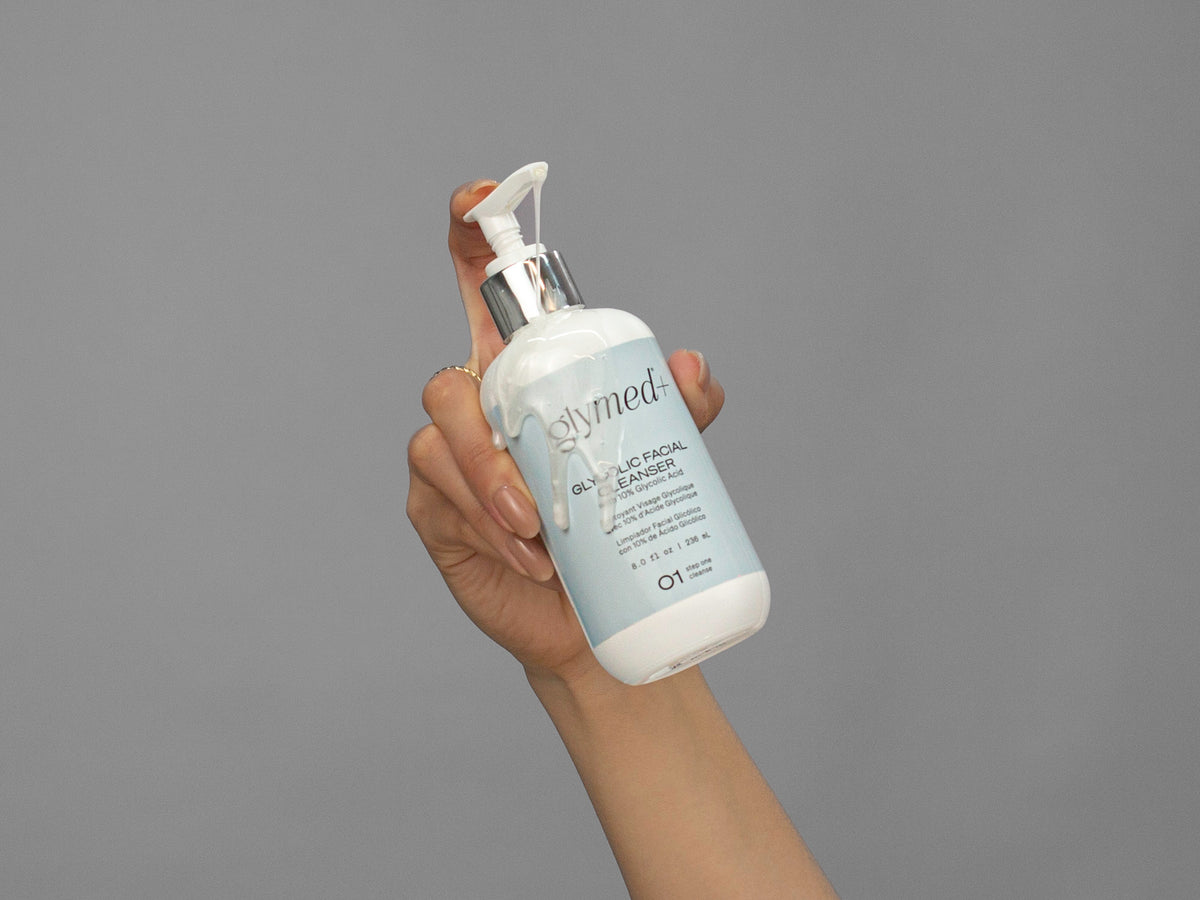 Closeup of Laziza from LAZ Skincare holding up a bottle of GlyMed Glycolic Facial Cleanser