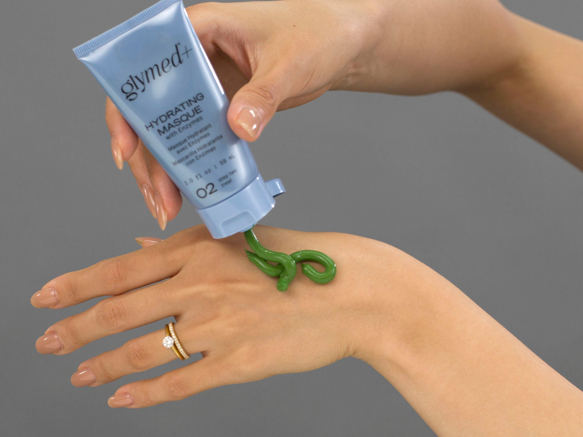 Closeup of Laziza from LAZ Skincare applying GlyMed Hydrating Masque to her hand