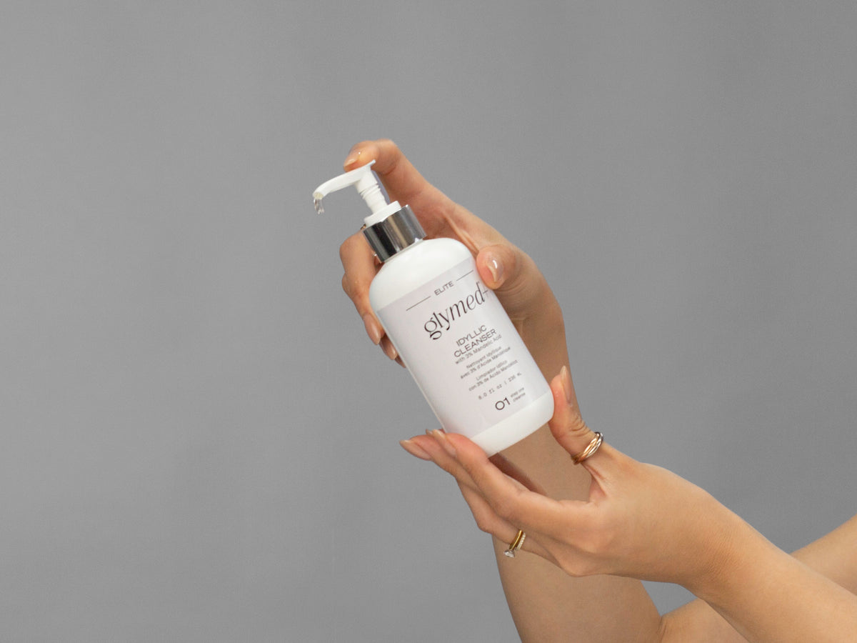 Closeup of Laziza from LAZ Skincare holding up a bottle of GlyMed Idyllic Cleanser