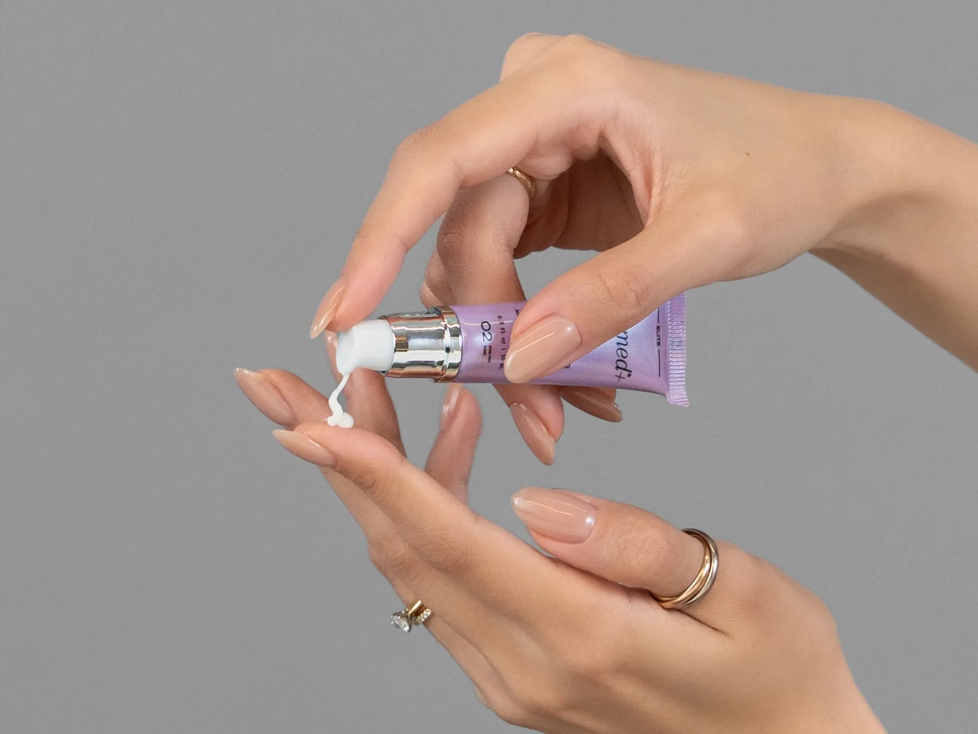 Laziza from LAZ Skincare demonstrating the texture and application of GlyMed Lip Enhancer on her hand