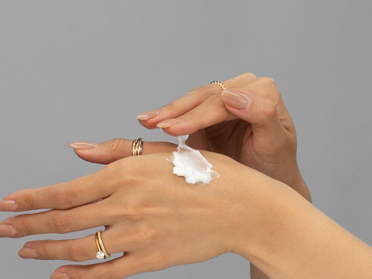 Laziza from LAZ Skincare demonstrating the texture and application of GlyMed Oxygen Cream on her hand