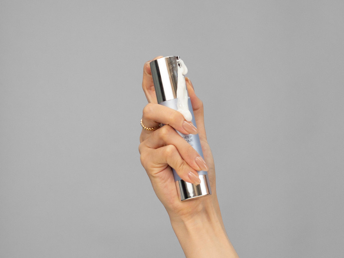 Closeup of Laziza from LAZ Skincare holding up a bottle of GlyMed Oxygen Deep Pore Masque