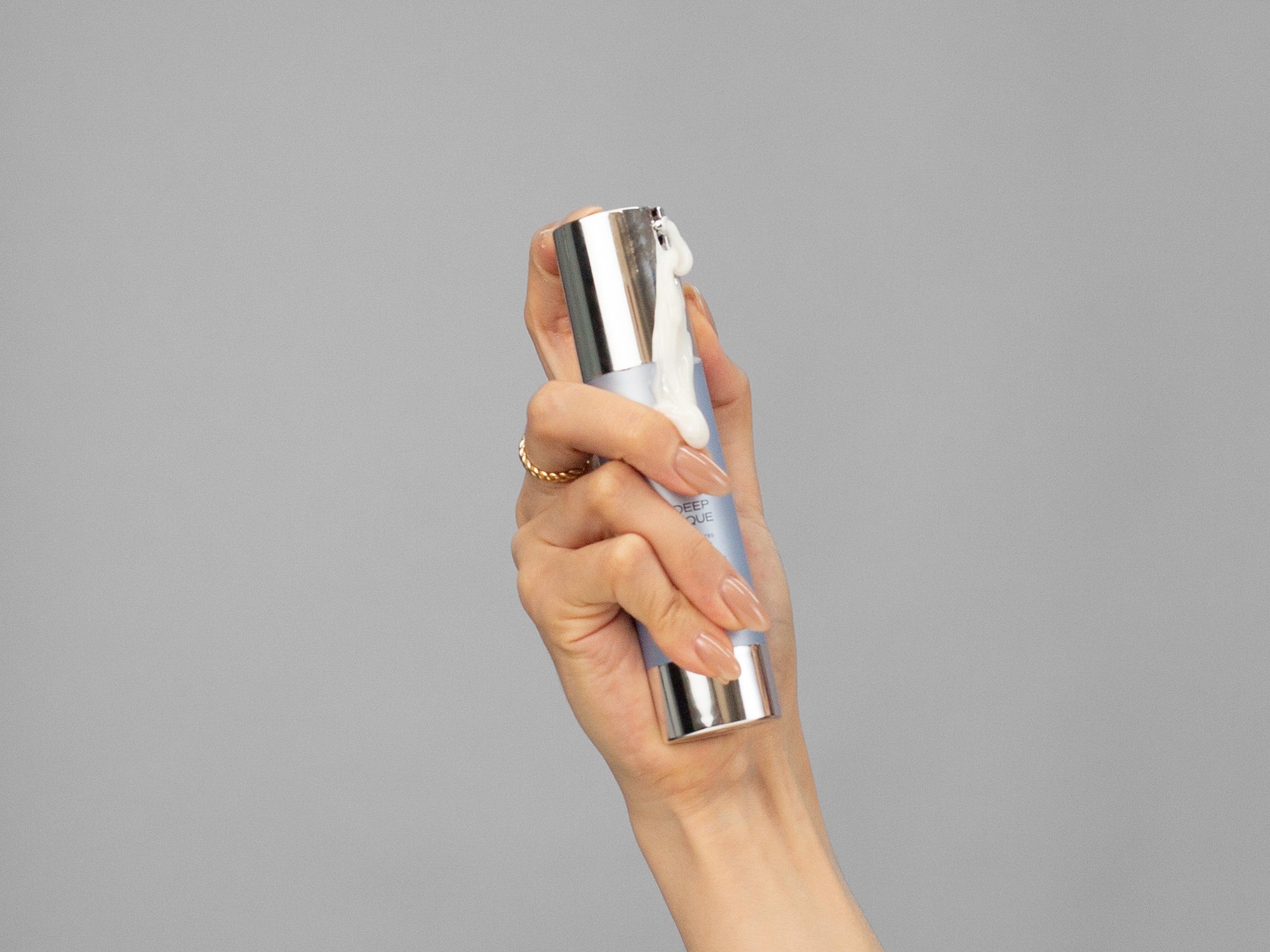 Closeup of Laziza from LAZ Skincare hold up a bottle of GlyMed Oxygen Deep Pore Masque in her hand