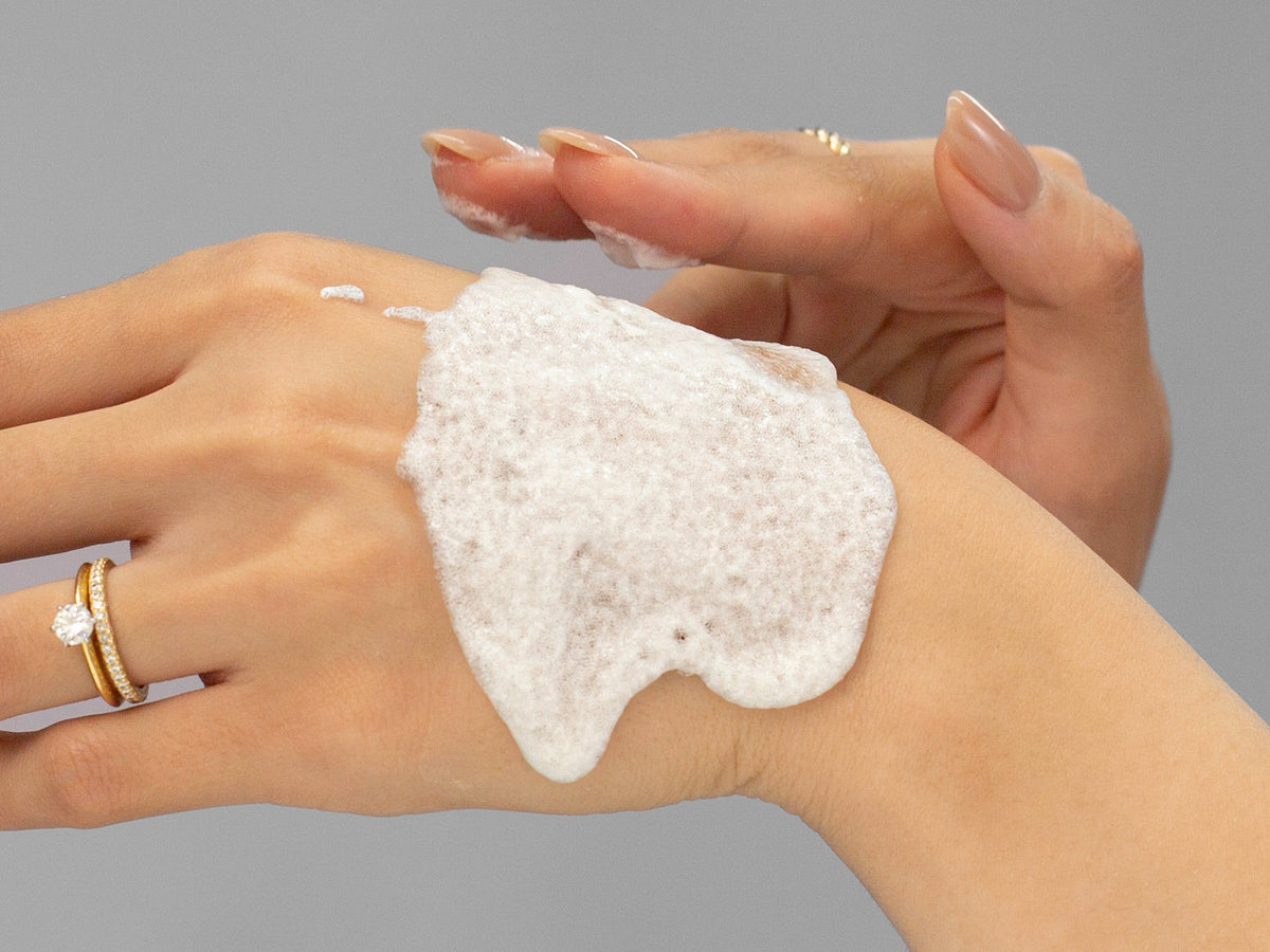 Laziza from LAZ Skincare demonstrating the texture and application of GlyMed Oxygen Deep Pore Masque on her hand