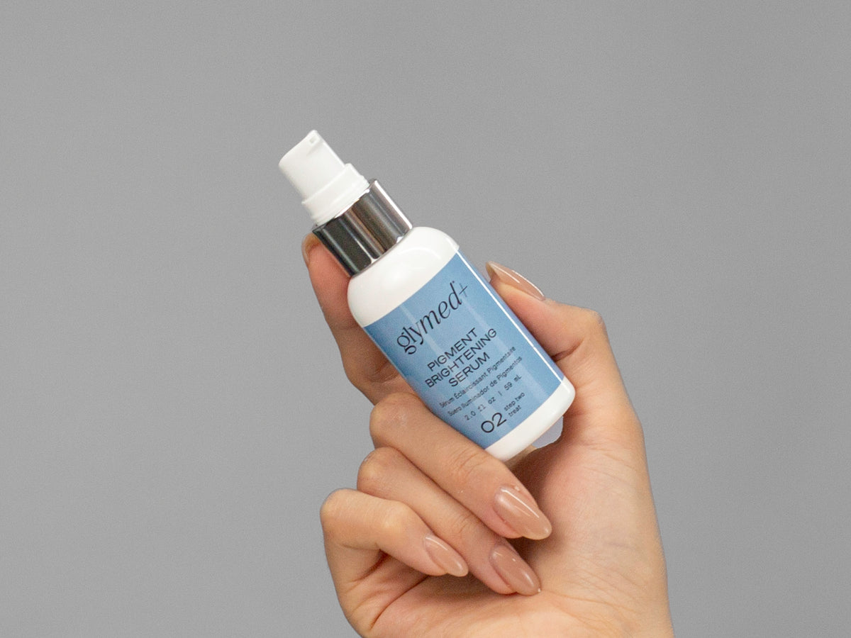 Closeup of Laziza from LAZ Skincare holding up a bottle of GlyMed Pigment Brightening Serum