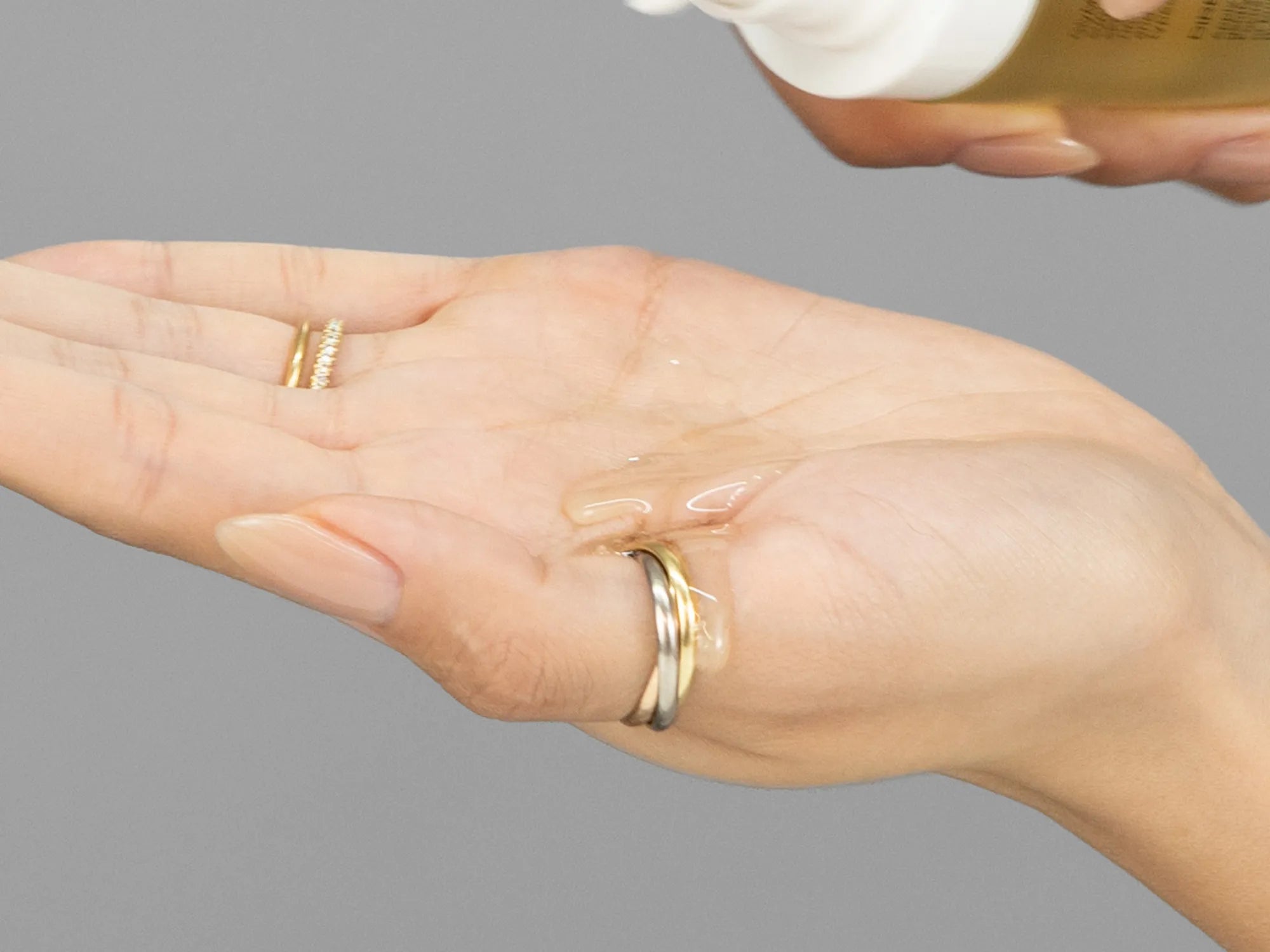 Laziza from LAZ Skincare demonstrating the texture and application of GlyMed Pure Glow SPF 60 Oil on her hand