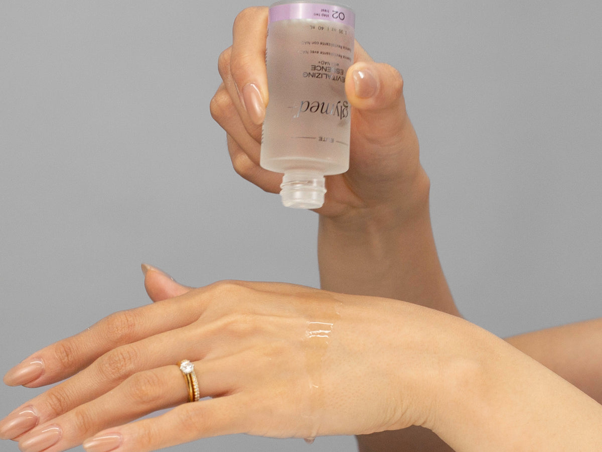 Laziza from LAZ Skincare demonstrating the texture and application of GlyMed Revitalizing Essence on her hand