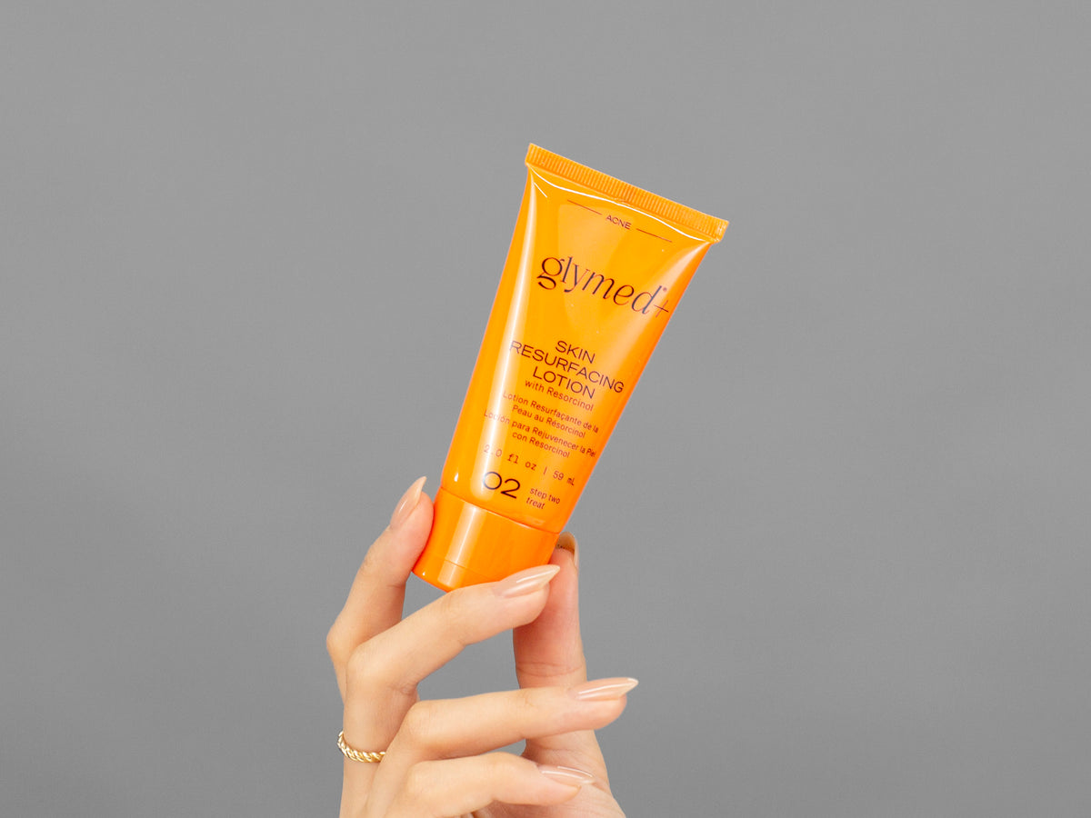 Closeup of Laziza from LAZ Skincare holding up a bottle of GlyMed Skin Resurfacing Lotion