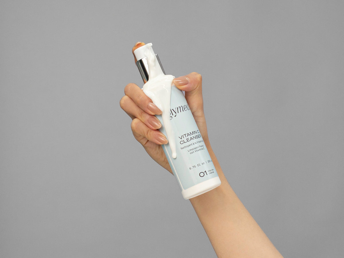 Closeup of Laziza from LAZ Skincare holding up a bottle of GlyMed Vitamin C Cleanser