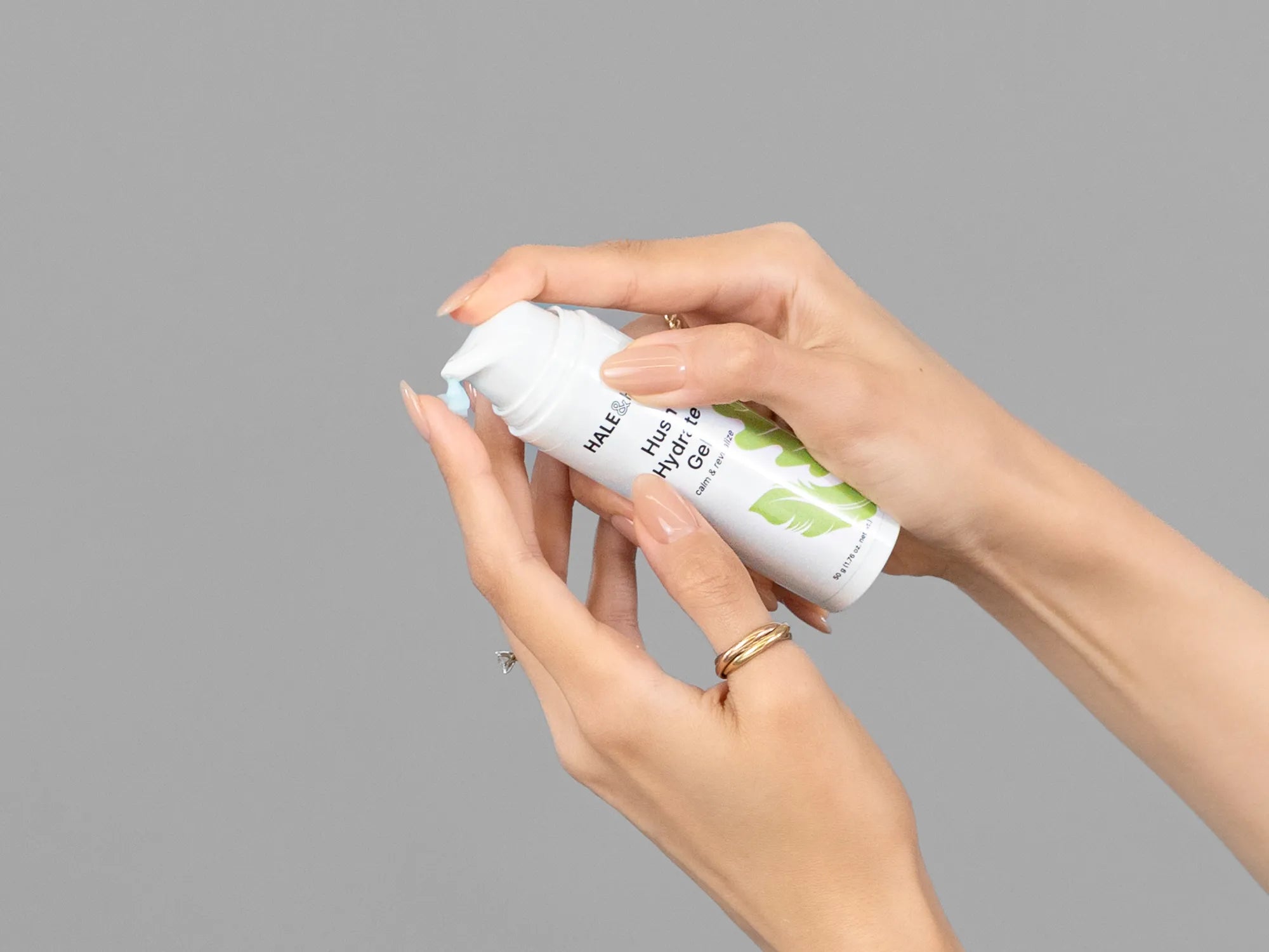 Closeup of Laziza from LAZ Skincare holding up a bottle of Hale & Hush Hush Hydrate Gel