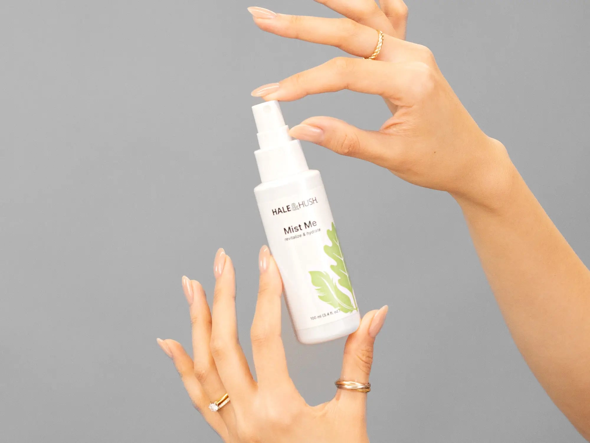 Closeup of Laziza from LAZ Skincare holding up a bottle of Hale & Hush Mist Me