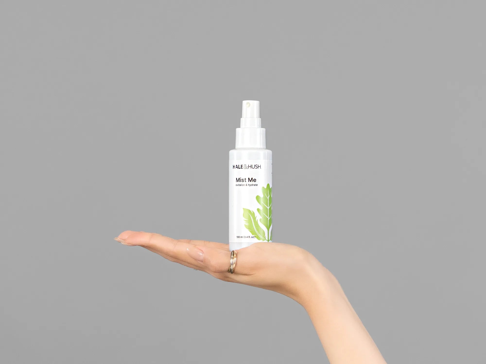 Closeup of Laziza from LAZ Skincare holding up a bottle of Hale & Hush Mist Me