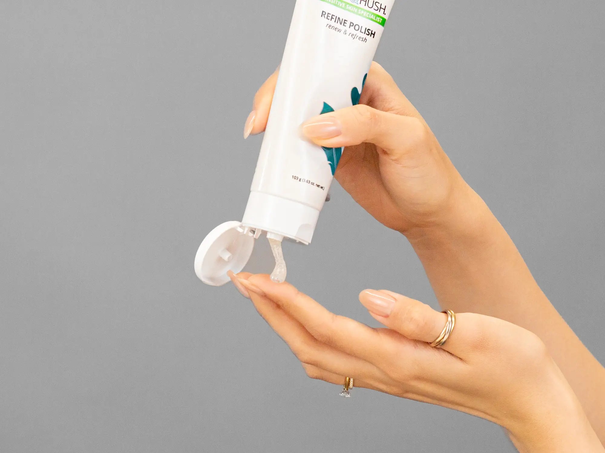Closeup of Laziza from LAZ Skincare holding up a bottle of Hale & Hush Refine Polish