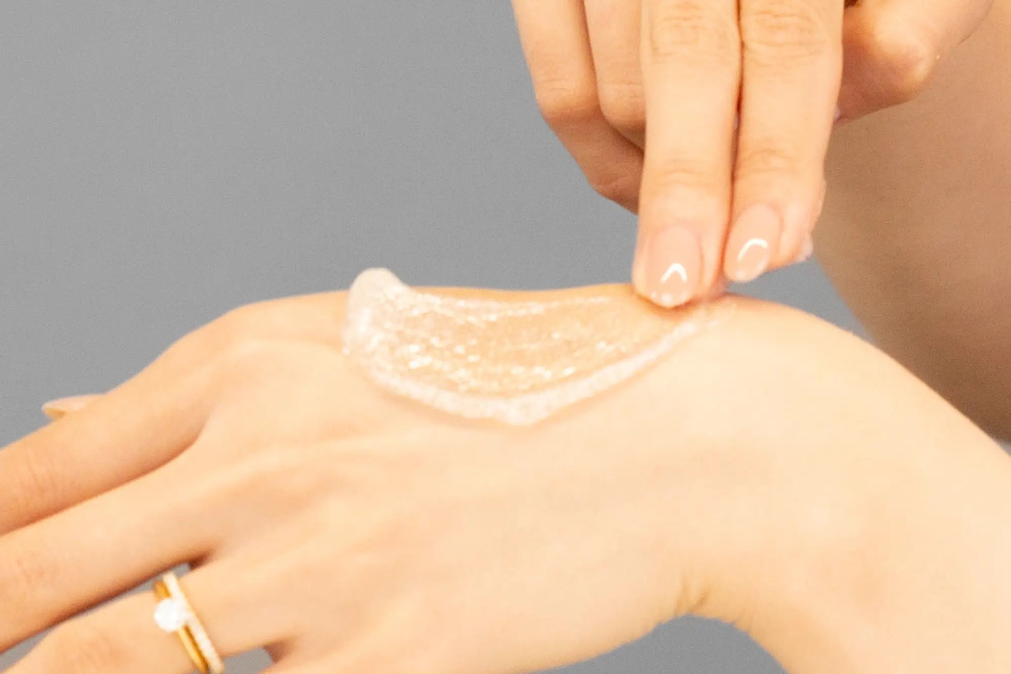 Laziza from LAZ Skincare demonstrating the texture and application of Hale & Hush Refine Polish on her hand