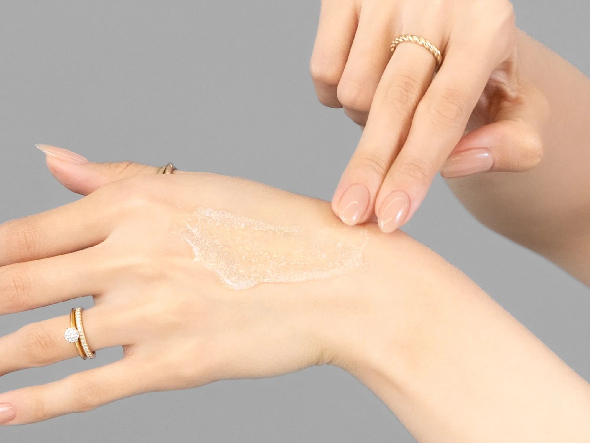 Laziza from LAZ Skincare demonstrating the texture and application of Hale & Hush Refine Polish on her hand