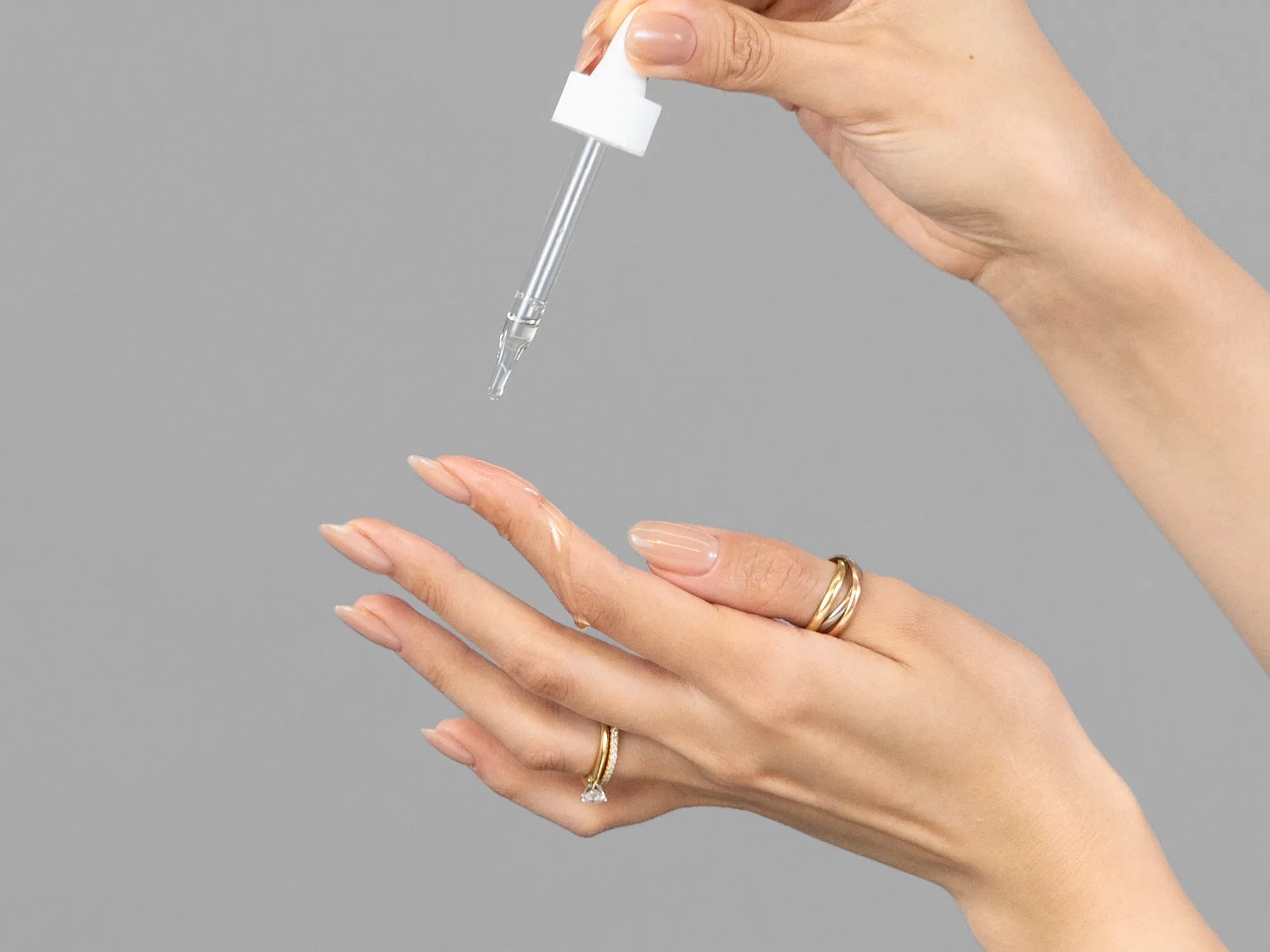 Laziza from LAZ Skincare demonstrating the texture and application of Hale & Hush Remedy Rehab Oil on her hand