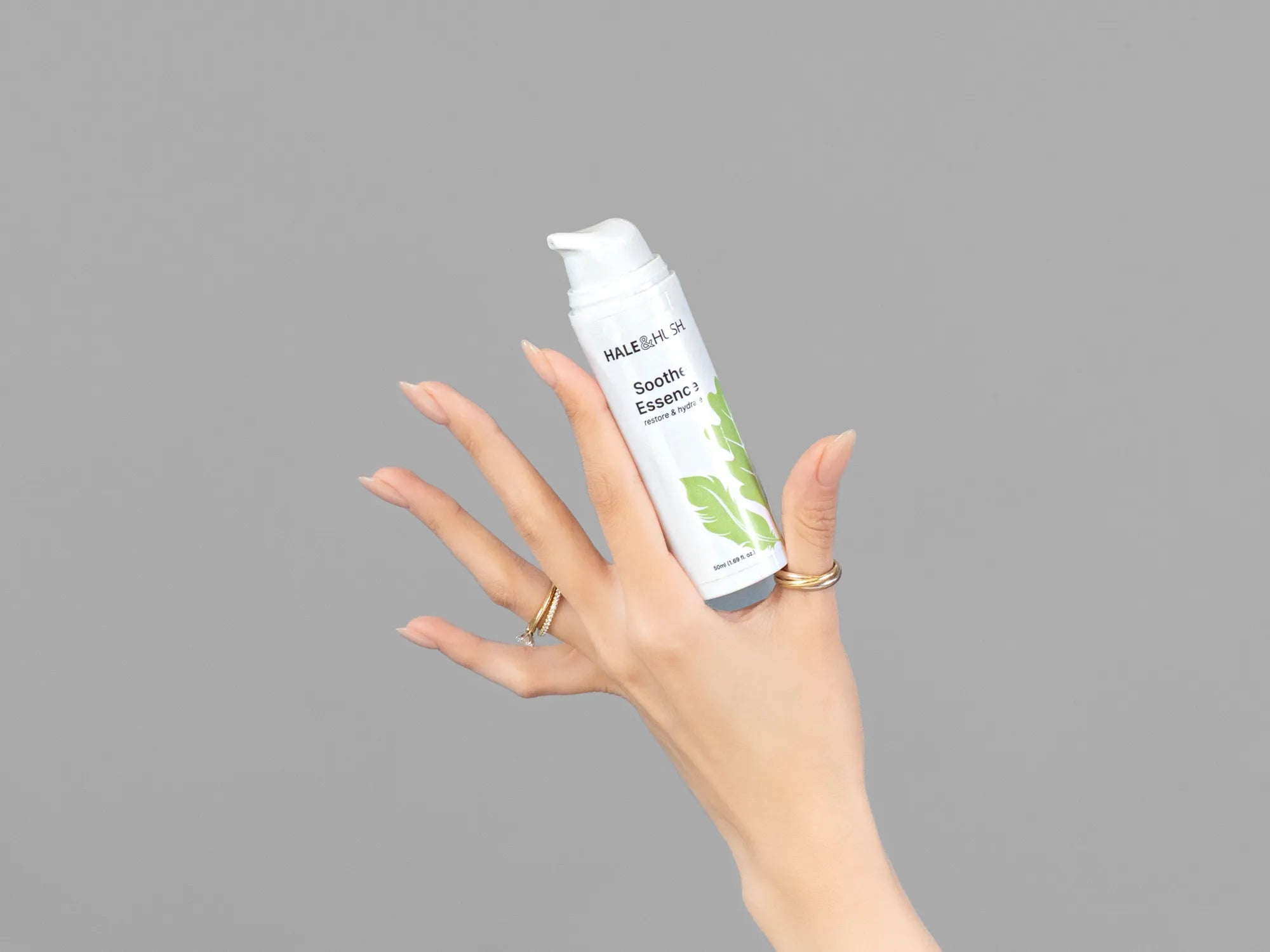 Closeup of Laziza from LAZ Skincare holding up a bottle of Hale & Hush Soothe Essence Serum