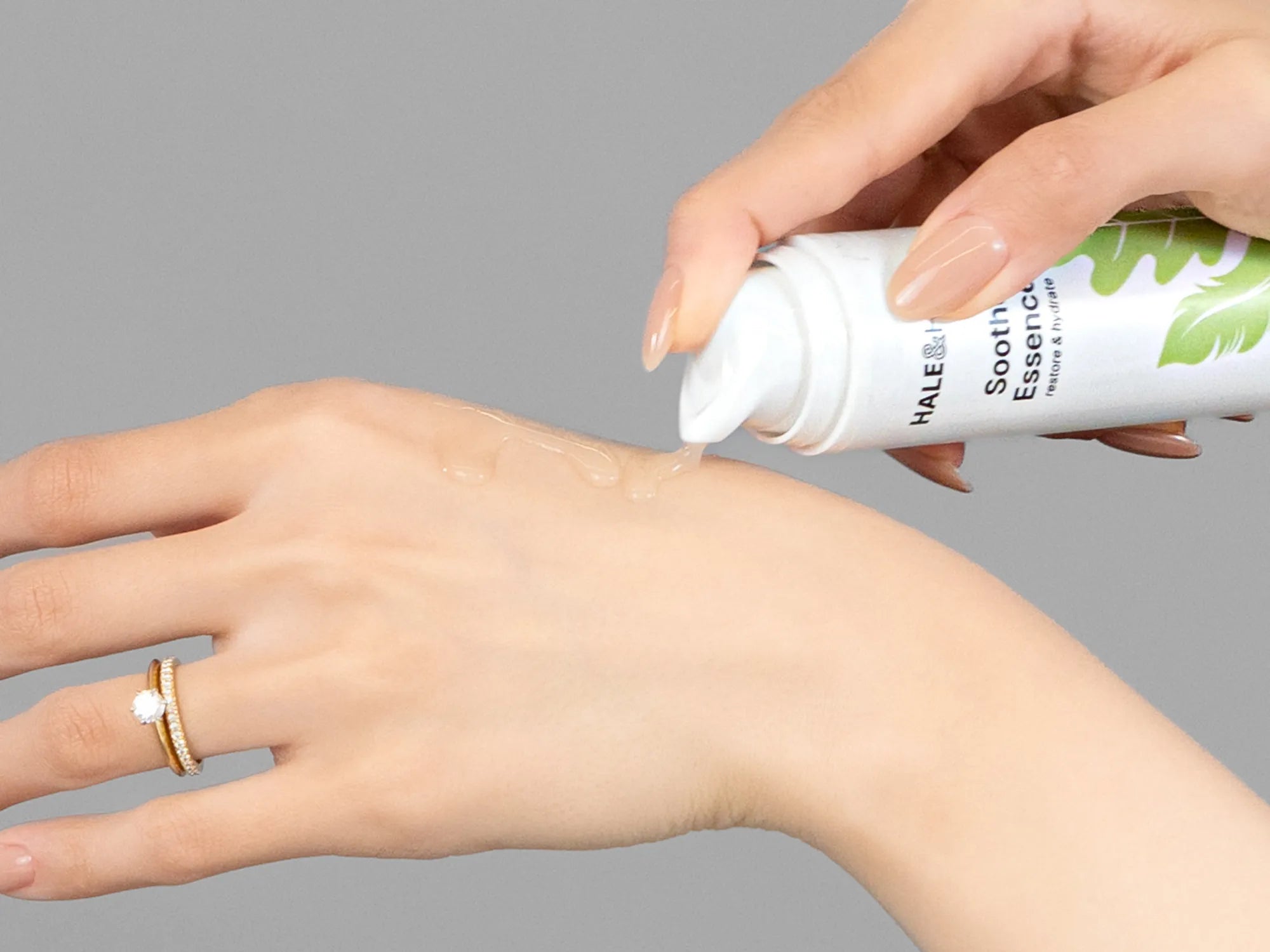 Laziza from LAZ Skincare demonstrating the texture and application of Hale & Hush Soothe Essence Serum on her hand