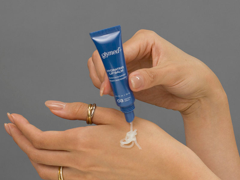 Laziza from LAZ Skincare demonstrating the texture and application of GlyMed Hydrating Lip Balm on her hand