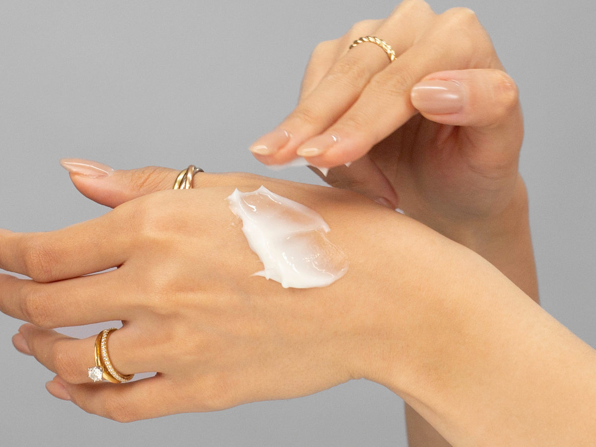 Laziza from LAZ Skincare demonstrating the texture and application of Hydrinity Eye Renew Complex on her hand
