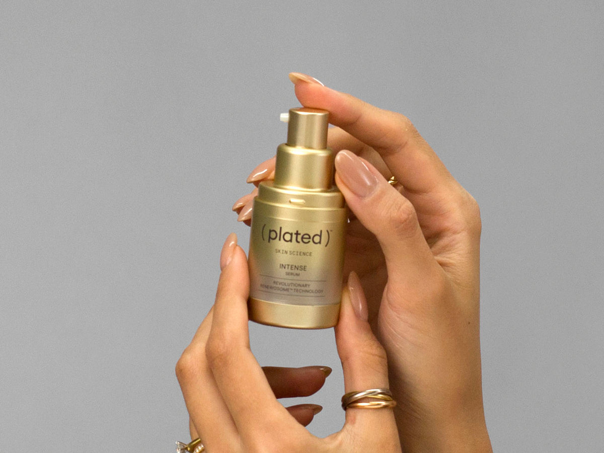 Closeup of Laziza from LAZ Skincare holding up a bottle of Plated Intense Serum