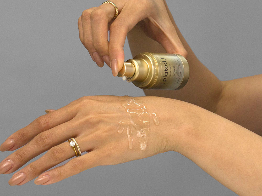 Laziza from LAZ Skincare demonstrating the texture and application of Plated Intense Serum on her hand