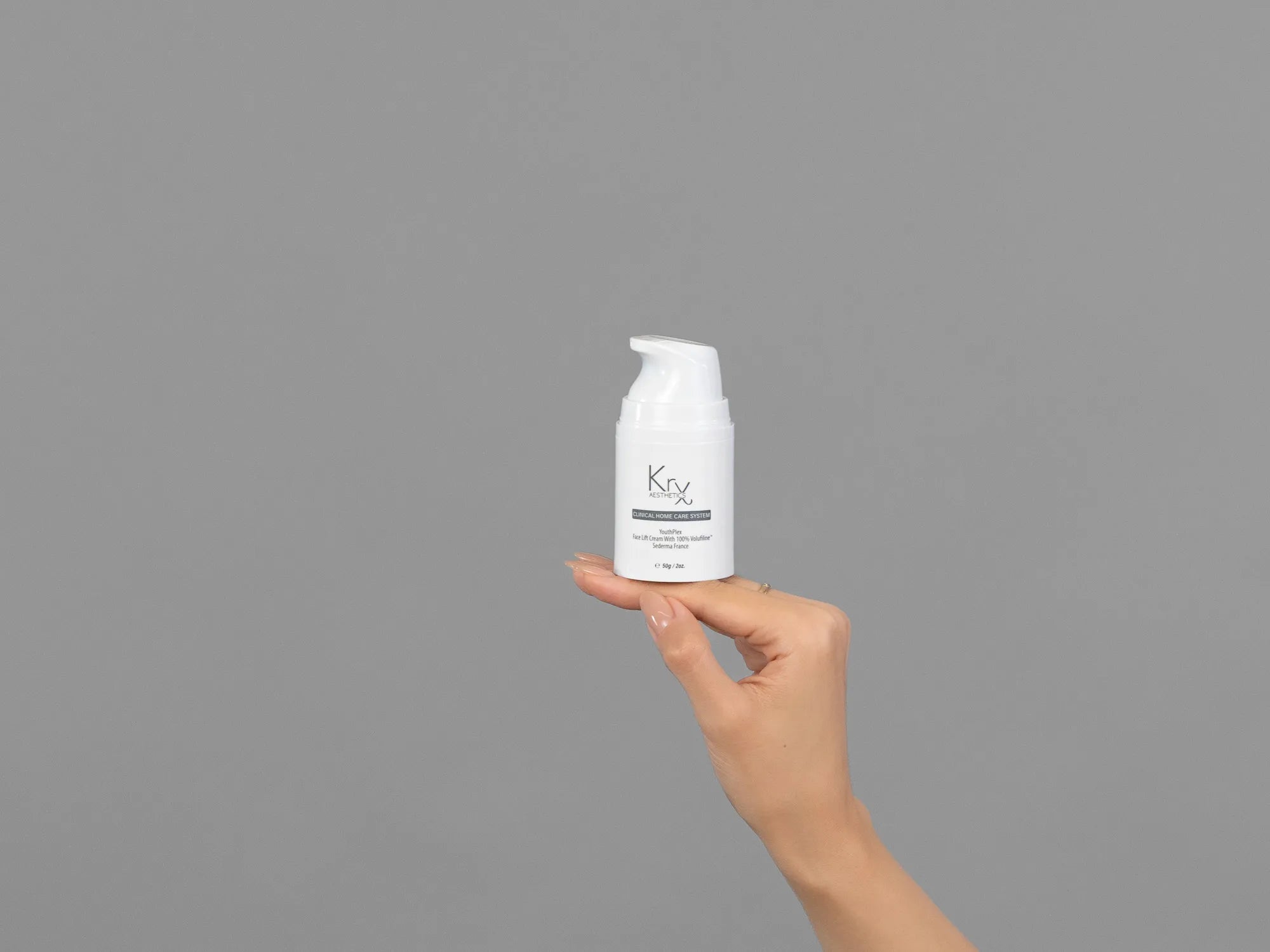 Closeup of Laziza from LAZ Skincare holding up a bottle of KrX Aesthetics Youthplex Face Lift Cream