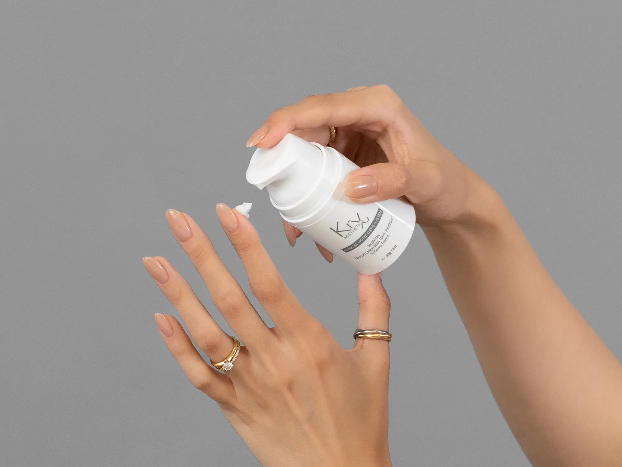 Laziza from LAZ Skincare demonstrating the texture and application of KrX Aesthetics Youthplex Face Lift Cream on her hand