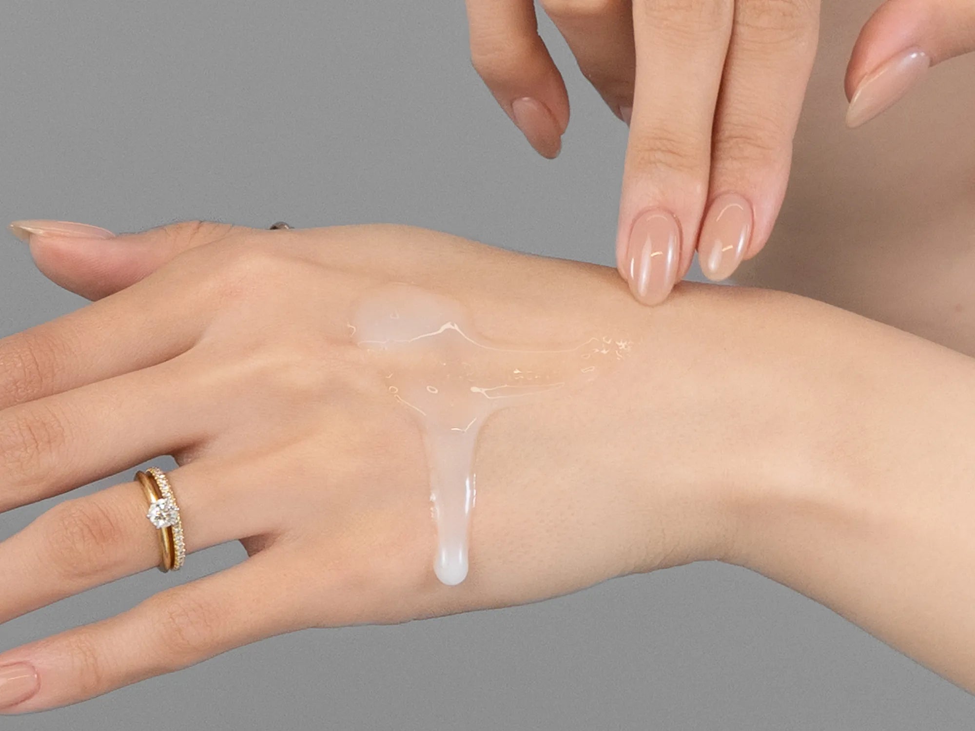 Laziza from LAZ Skincare demonstrating the texture and application of KrX Aesthetics Youthplex Face Lift Serum on her hand