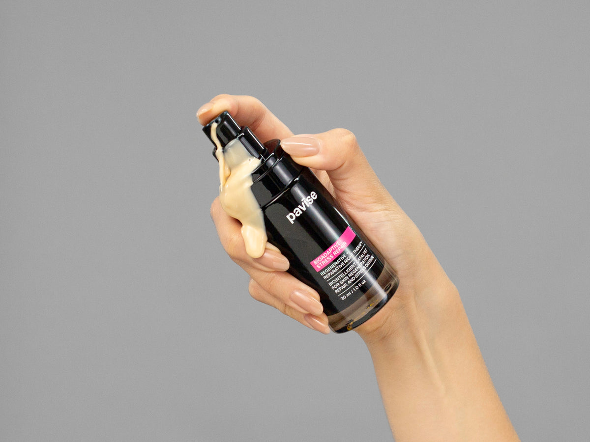 Closeup of Laziza from LAZ Skincare holding up a bottle of Pavise Bioadaptive Stress Repair