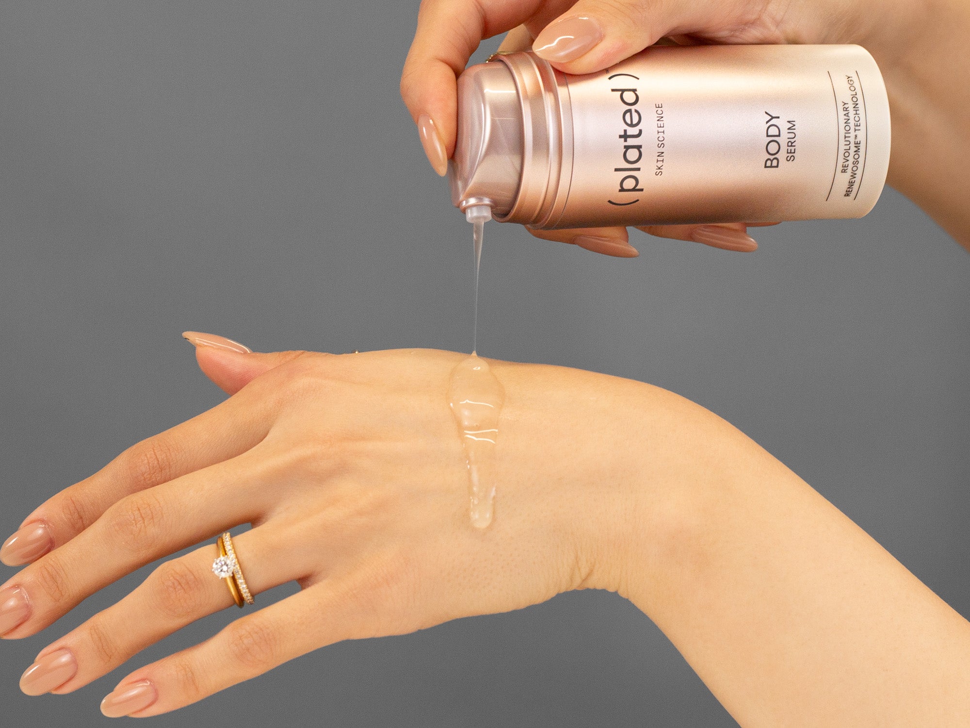 Laziza from LAZ Skincare demonstrating the texture and application of Plated Body Serum on her hand