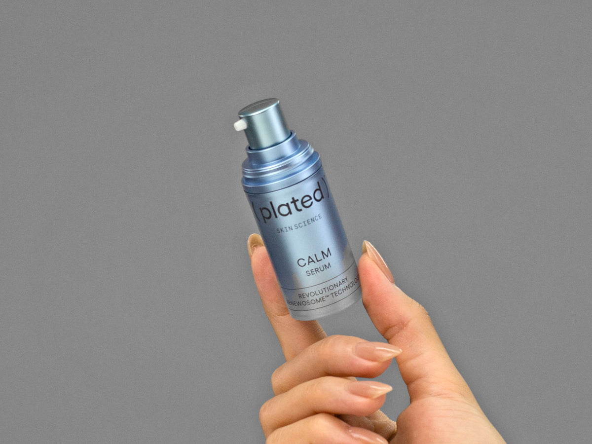 Closeup of Laziza from LAZ Skincare holding up a bottle of Plated Calm Serum