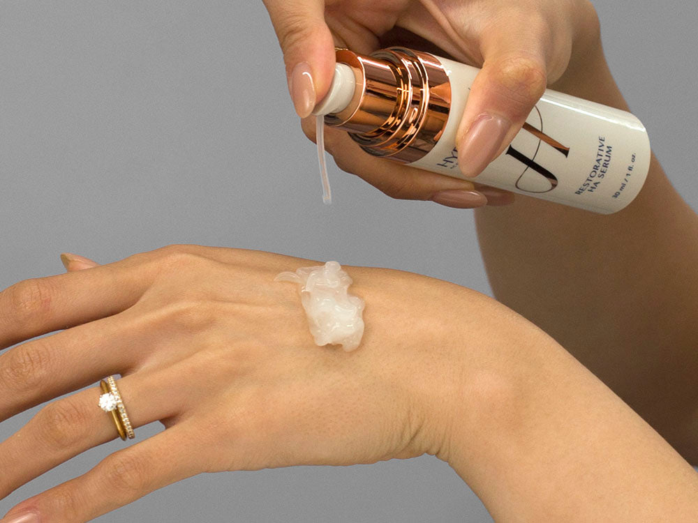 Laziza from LAZ Skincare demonstrating the texture and application of Hydrinity Renewing HA Serum on her hand