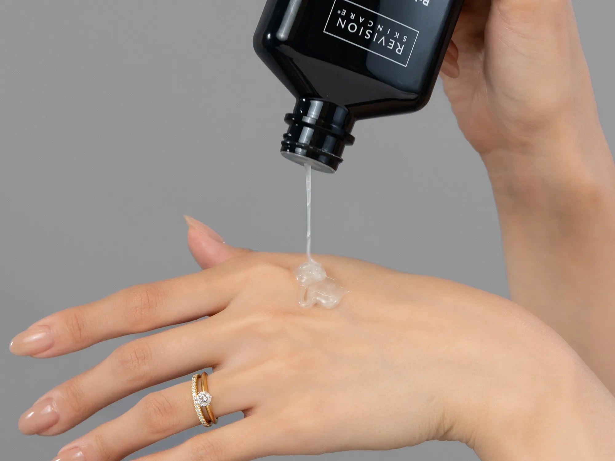 Laziza from LAZ Skincare demonstrating the texture and application of Revision Brightening Facial Wash on her hand
