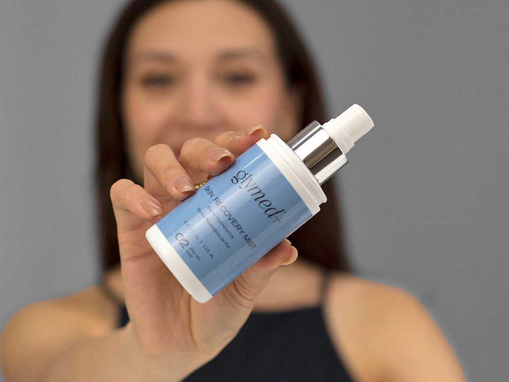 Laziza from LAZ Skincare demonstrating the texture and application of GlyMed Skin Recovery Mist on her hand