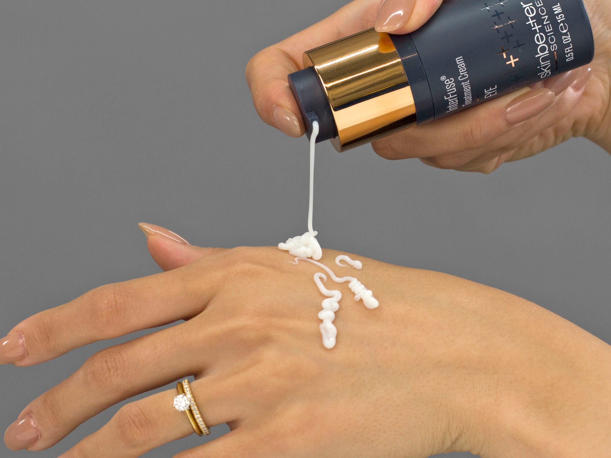 Closeup of Laziza from LAZ Skincare applying Skinbetter Science InterFuse Treatment Cream EYE to her hand