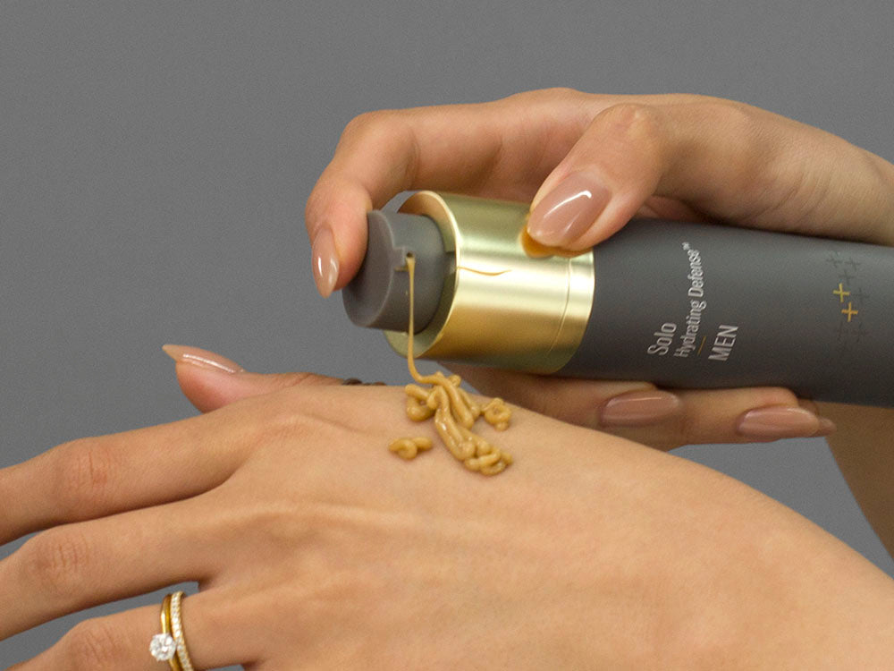 Laziza from LAZ Skincare demonstrating the texture and application of SkinBetter Science Solo Hydrating Defense MEN on her hand