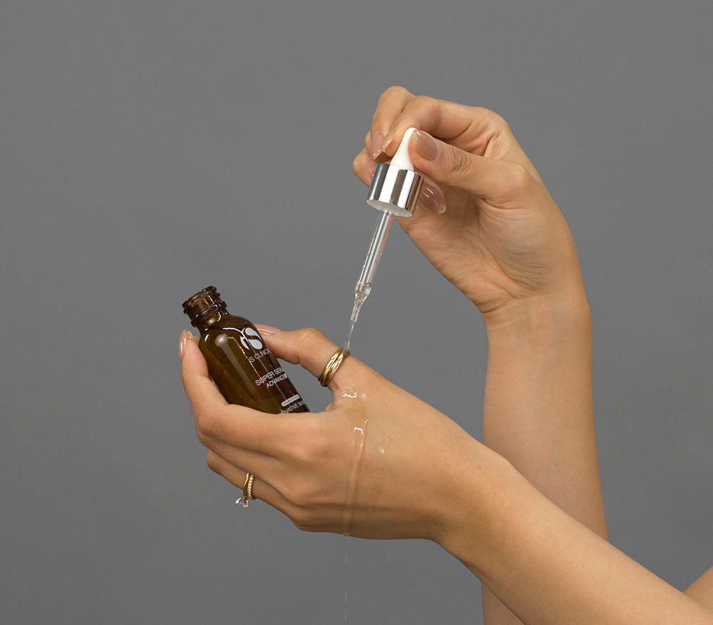 Laziza from LAZ Skincare demonstrating the texture and application of iS Clinical Super Serum Advance+ on her hand