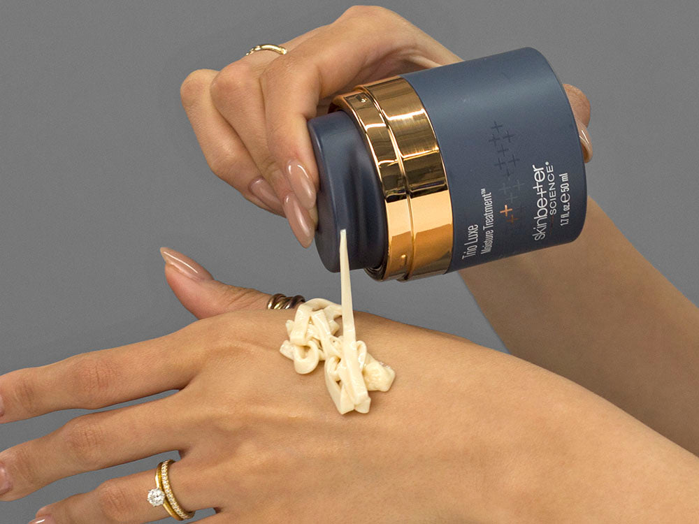Laziza from LAZ Skincare demonstrating the texture and application of SkinBetter Science Trio Luxe Moisture Treatment on her hand