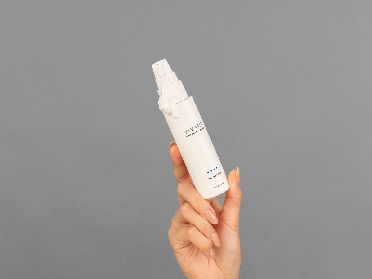 Closeup of Laziza from LAZ Skincare holding up a bottle of Vivant Allantoin