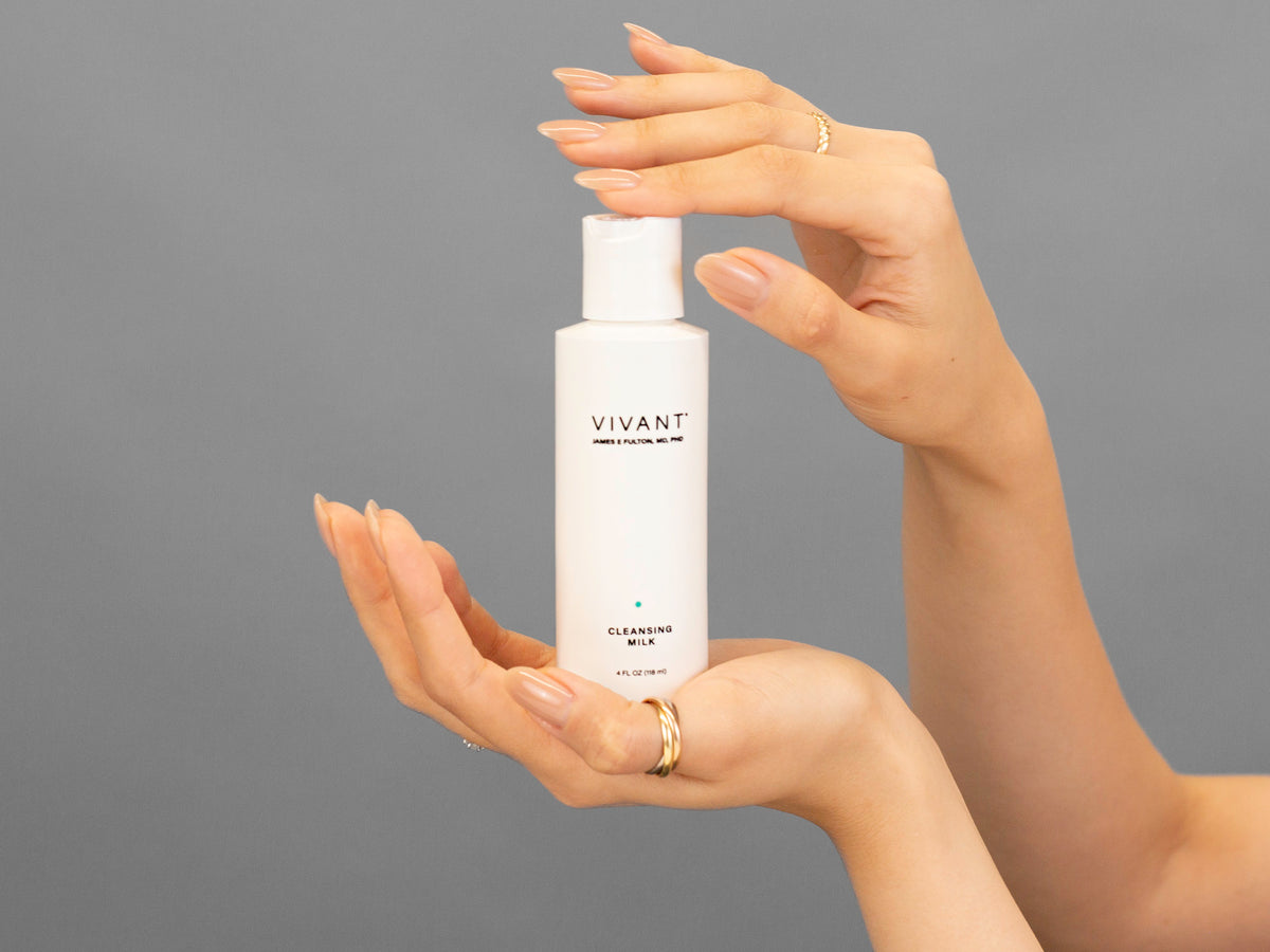 Closeup of Laziza from LAZ Skincare holding up a bottle of Vivant Cleansing Milk