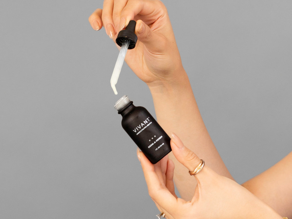 Closeup of Laziza from LAZ Skincare holding up a bottle of Vivant Derm-A-Renew
