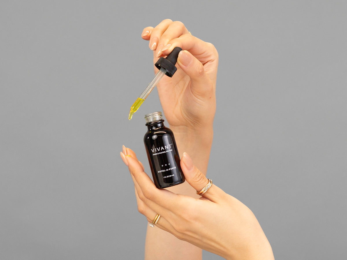 Closeup of Laziza from LAZ Skincare holding up a bottle of Vivant Exfol-A Forté