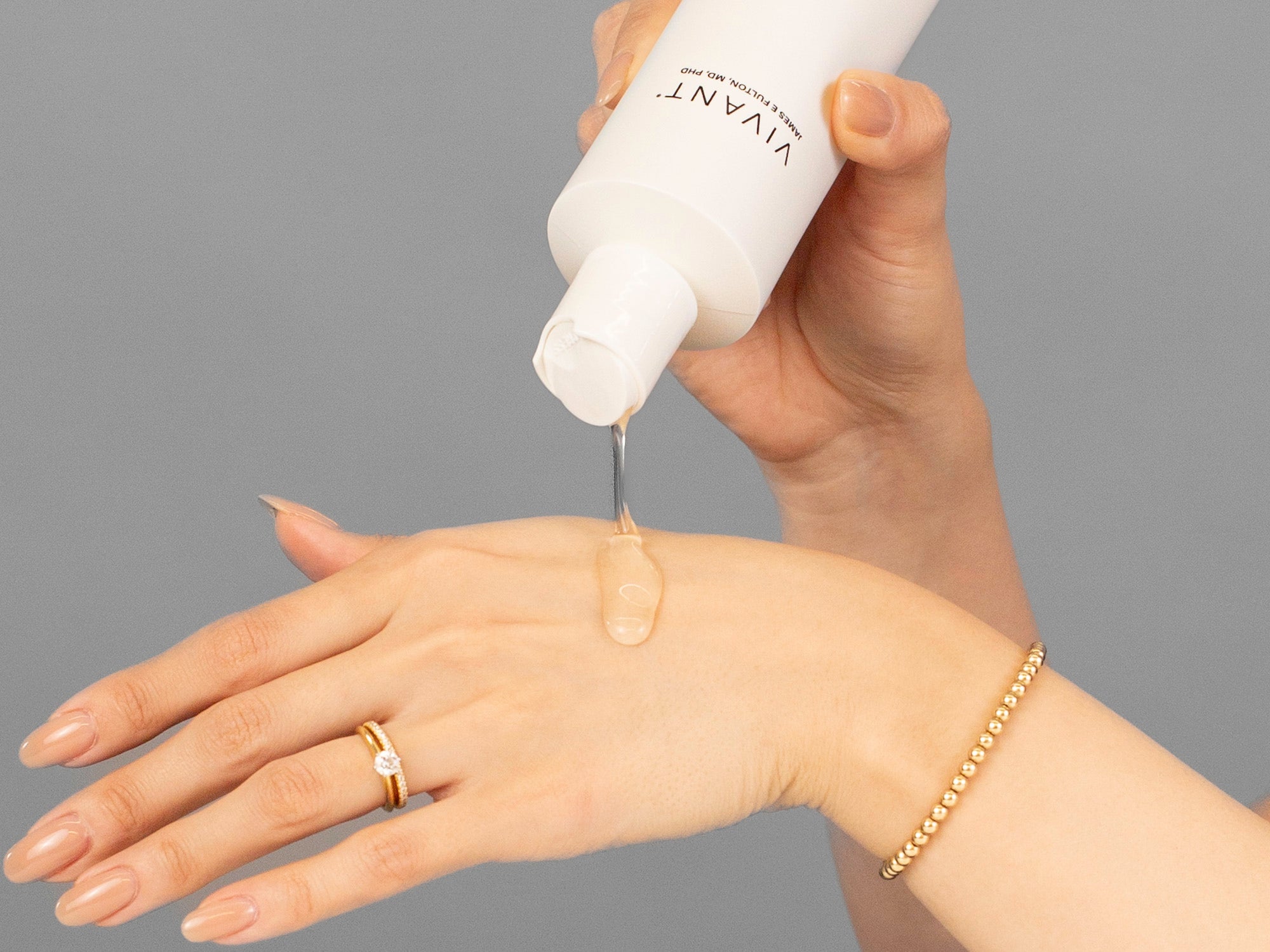 Closeup of Laziza from LAZ Skincare applying Vivant Green Tea Antioxidant Cleanser to her hand