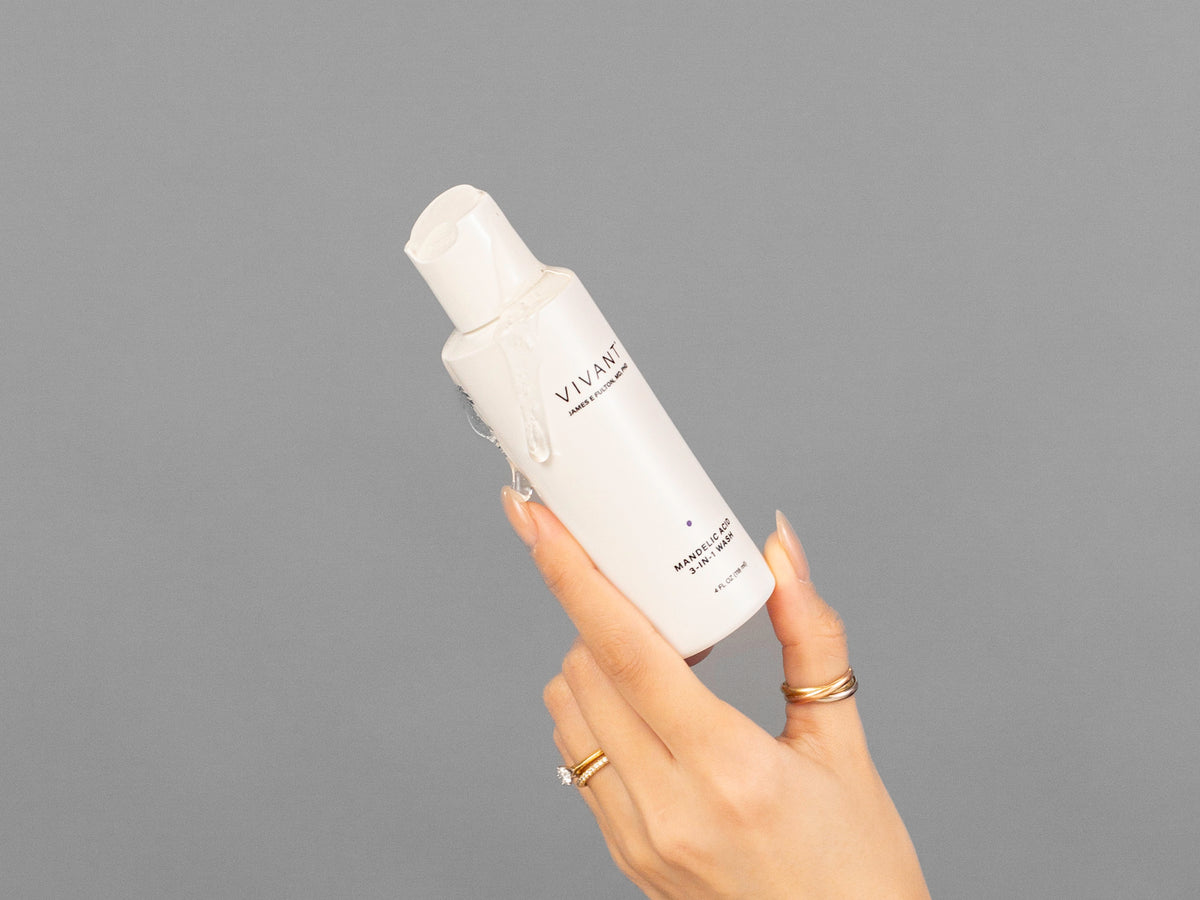 Closeup of Laziza from LAZ Skincare holding up a bottle of Vivant Mandelic Acid 3-in-1 Wash