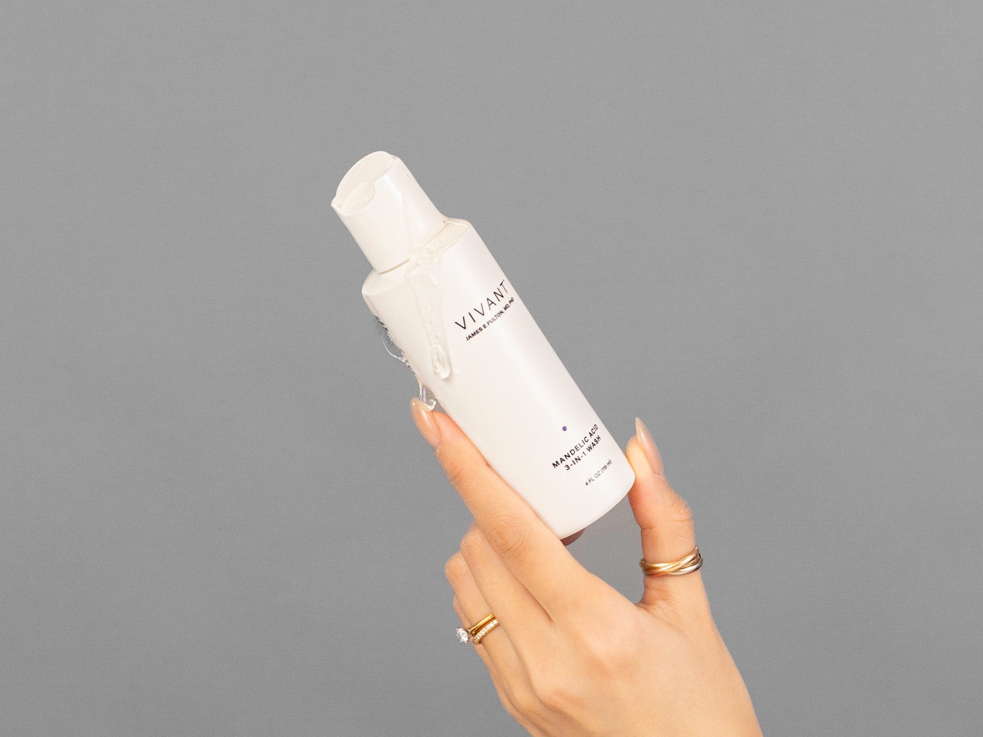 Closeup of Laziza from LAZ Skincare holding a bottle of Vivant Mandelic Acid 3-in-1 Wash in her hand